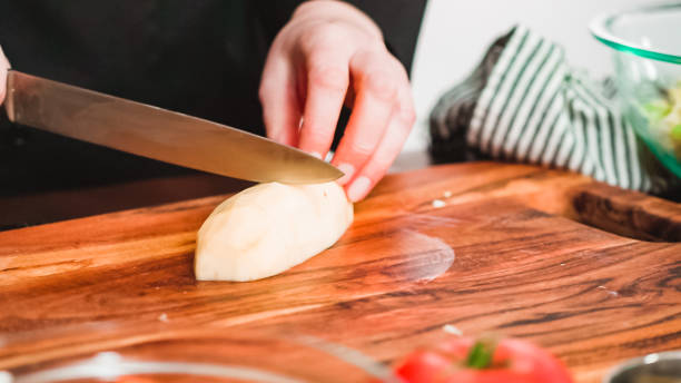 istock Peeling and slicing large gold potatoes 1181944712