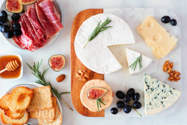 istock Platter of assorted cheeses and meats, top view table scene on a bright background 1181946146