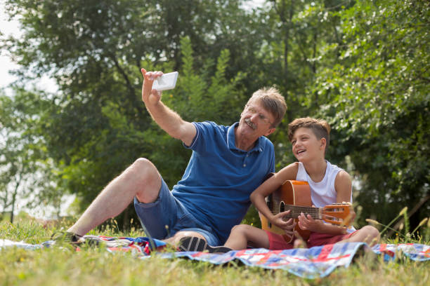 istock Older man taking selfie with grandson 1181946837