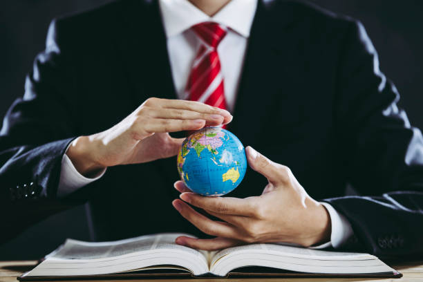 istock Businessman holding a world globe 1181960980
