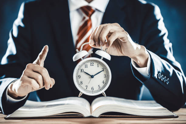 istock Businessman with alarm clock 1181960986