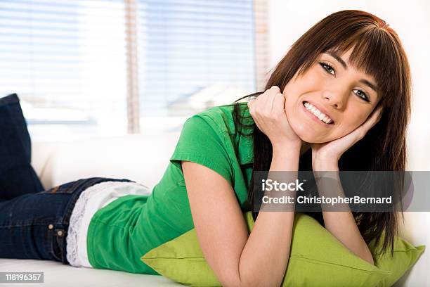 Smiling Teenagar Lying On The Couch Stock Photo - Download Image Now - Bangs - Hair, 16-17 Years, Adolescence