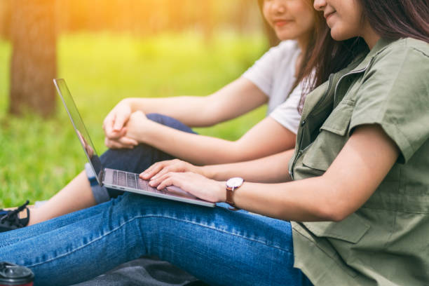 istock women working and using laptop computer while sitting in the park 1181966835