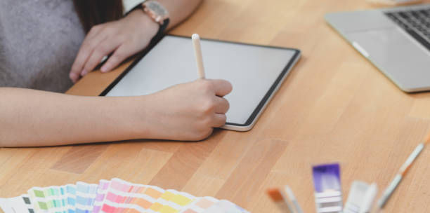 istock Close-up view of young female designer planing his project while tablet 1181972030