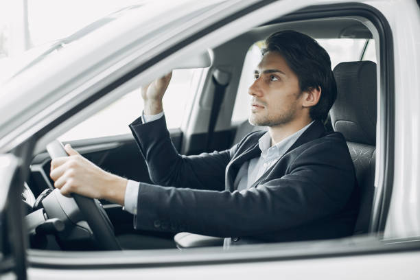 istock Handsome and elegant man in a car salon 1181975601