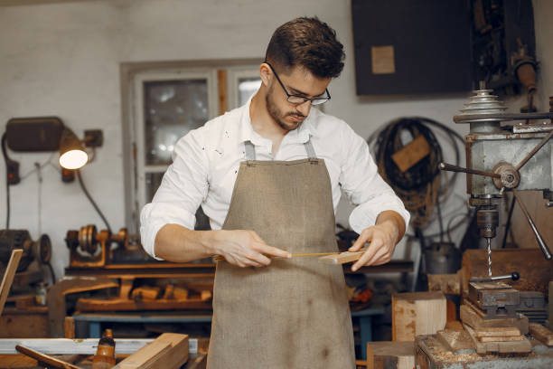 istock Handsome carpenter working with a wood 1181977170