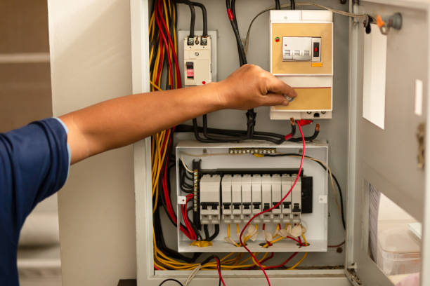 istock Senior electrician measuring voltage in fuse board. 1181982876