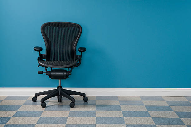 Office Chair Single office chair in austere office.* office chair stock pictures, royalty-free photos & images