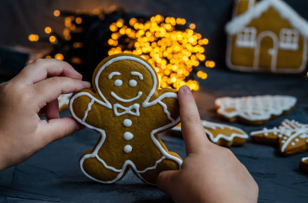 istock Christmas gingerbread with white icing sugar painted on a dark background. 1181984709