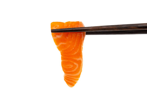 istock Salmon raw sashimi with chopsticks on a white background 1181986214