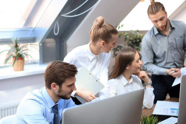 istock Startup business team on meeting in modern bright office interior brainstorming, working on tablet and PC computers. 1181989067