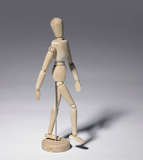 istock wooden doll in grey back 118199129