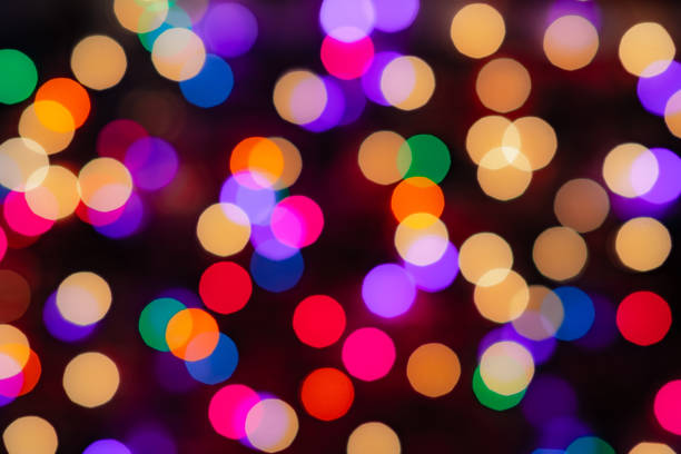 istock MODERATE BOKEH background image of Christmas lights out of focus.  This version has a medium sized, soft round Bokeh effect with many vivid colors bleeding together.  The entire image is space for copy writing.  Great for background replacements 1181995983