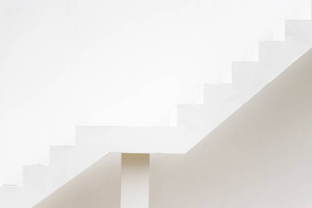 istock White staircase on concrete wall background (Concept for career path, target aiming, aspiration) 1181996978