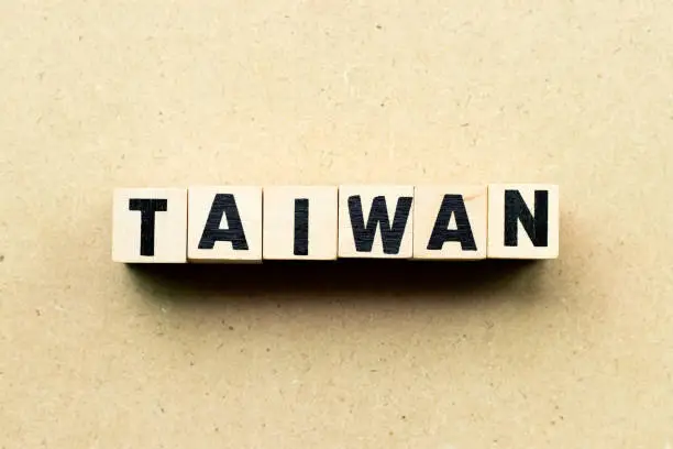 Photo of Letter block in word Taiwan on wood background