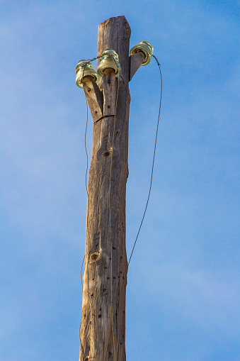 vintage power lines on a wooden pole, power line column, abandoned pole, vintage wooden pole