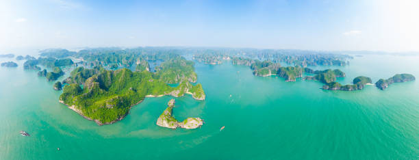 aerial view lan ha bay cat ba island ha long bay, unique limestone rock islands and karst formation peaks in the sea, famous tourism destination in vietnam. scenic blue sky. - halong bay vietnam bay cruise imagens e fotografias de stock