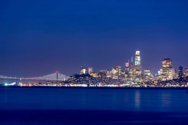 San Francisco Bay from Sausalito at Dawn San Francisco skyline as seen from Sausalito harbor at dawn with city lights sausalito stock pictures, royalty-free photos & images