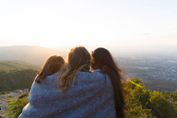 istock Women on mountain peak cliff 1182002880