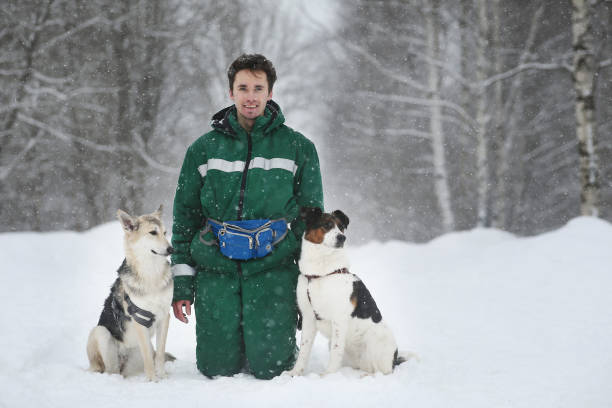 istock Two dogs walk outdoors in winter with an owner 1182003699