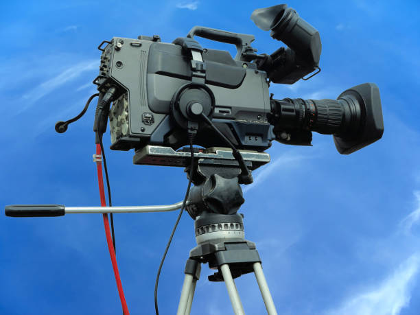 istock TV Professional studio digital video camera on tripod over blue sky 1182005143
