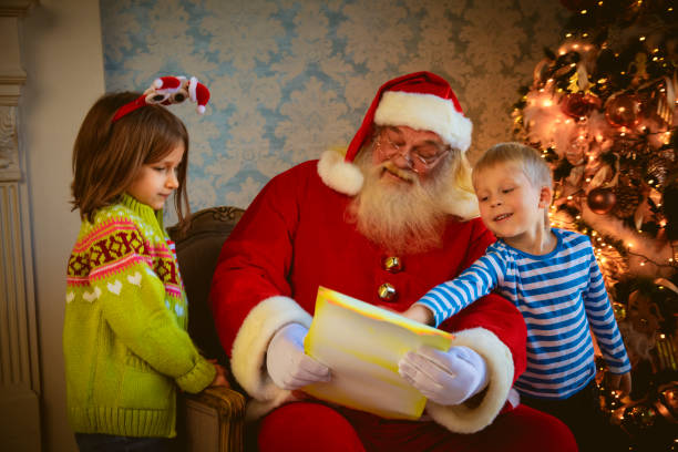 istock Santa Claus gives presents 1182007152