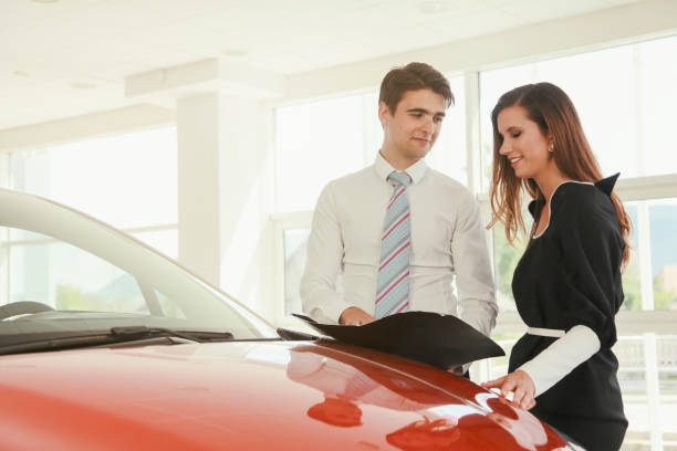 istock Young woman buying a new car 1182010207