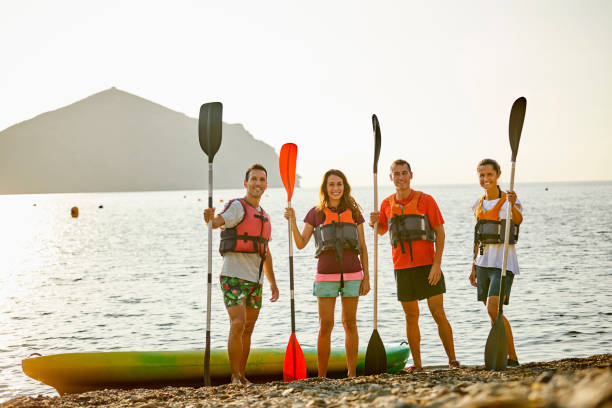 istock Friends with oars at riverbank during vacation 1182012086
