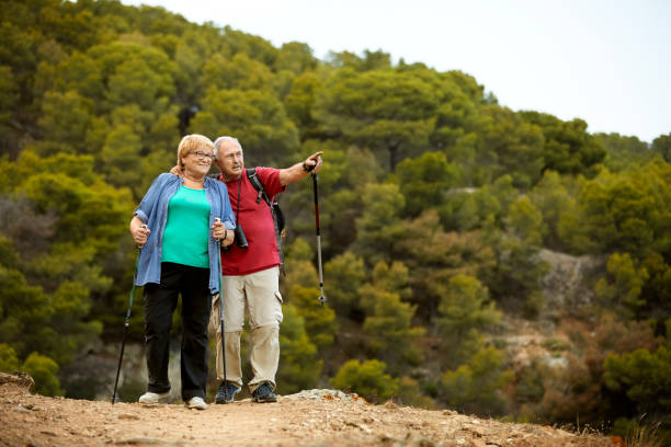 istock Elderly couple hiking together on mountain 1182012472