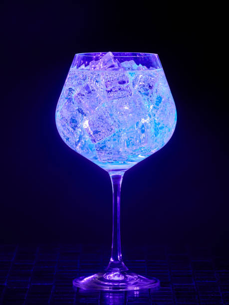 Gin tonic under UV illumination stock photo