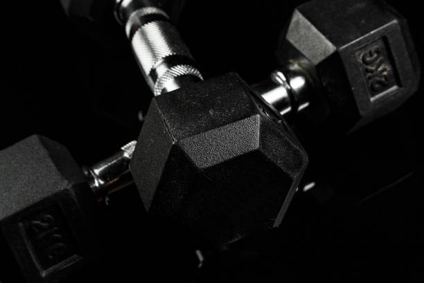 istock sports dumbbells with black rubber handle on black isolated background 1182015133