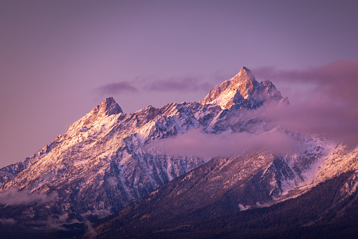 Colorful mountain peak covered by snow and cloud of Grand Teton National Park, Wyoming, USA at sunrise.