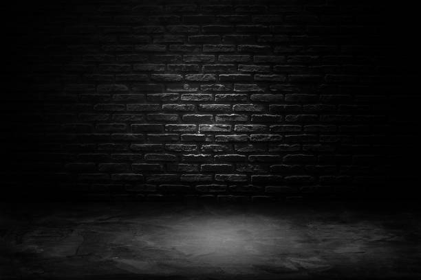 istock Studio dark room black brick wall with concrete floor. 1182024162