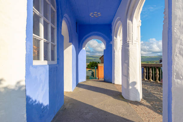 Lilac painted porch overlooking an estuary in Portmeirion, Penrhyndeudraeth, Wales Penrhyndeudraeth, Wales, UK - Aug 15, 2019: Lilac painted porch overlooking an estuary in Portmeirion taken at the end of the afternoon with no people portmeirion stock pictures, royalty-free photos & images