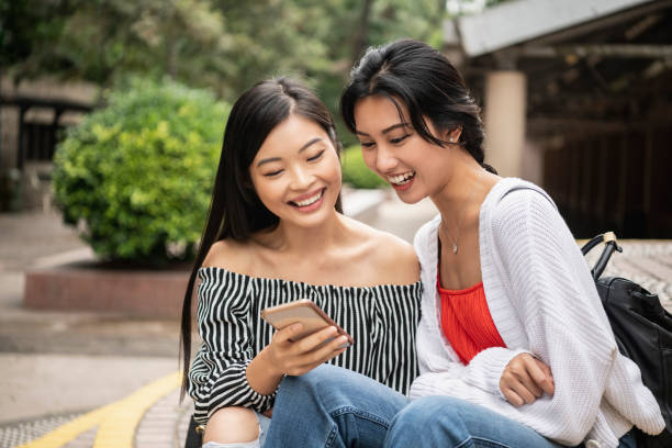 istock Two Chinese women checking mobile phone 1182027734