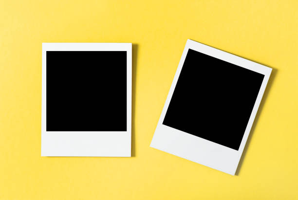 istock Photo frames yellow background Flat lay 1182028710