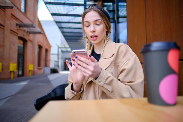 istock woman using smartphone in caffee shop. smart phone or mobile 1182030122