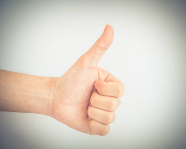 istock Filtered image studio shot index Asian man hand with thumbs up isolated on white 1182030184