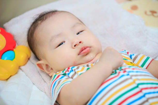 istock Cute baby lying on bed 1182031478