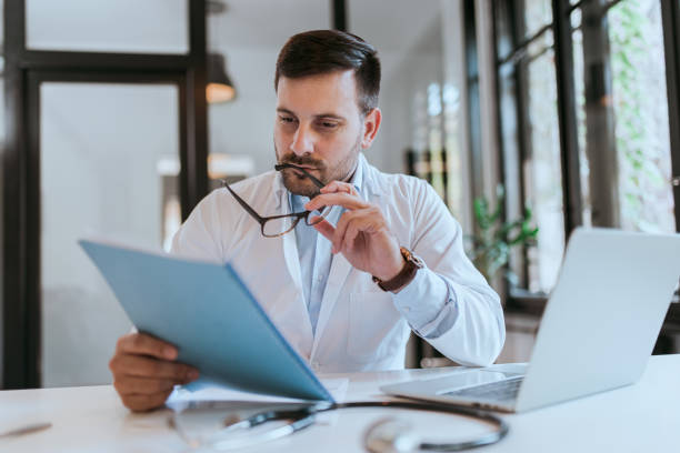 istock Portrait of a doctor reading a file. 1182032148