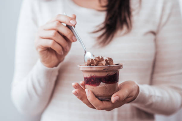 istock Woman eating chocolate dessert in a jar. 1182032352