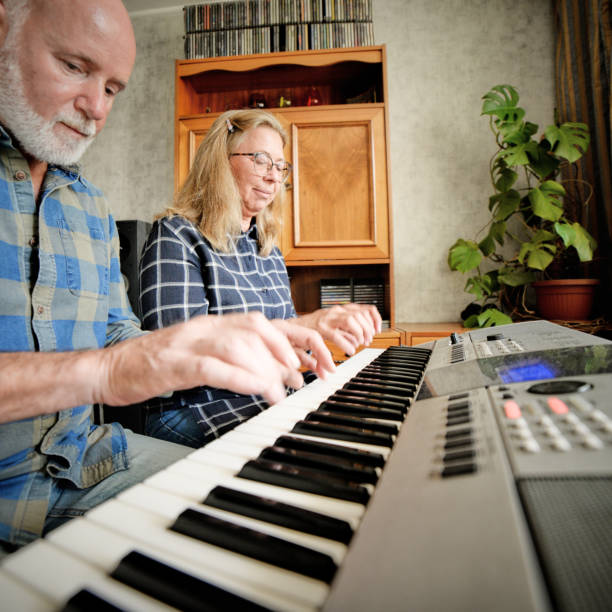 istock attractive couple playing piano at home 1182033158