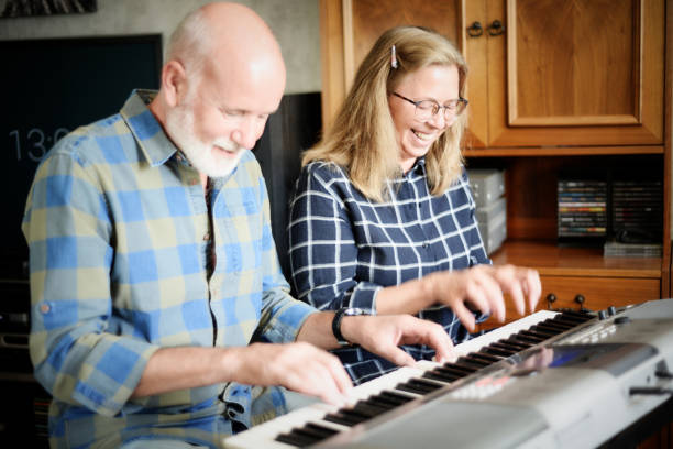 istock attractive couple playing piano at home 1182033511