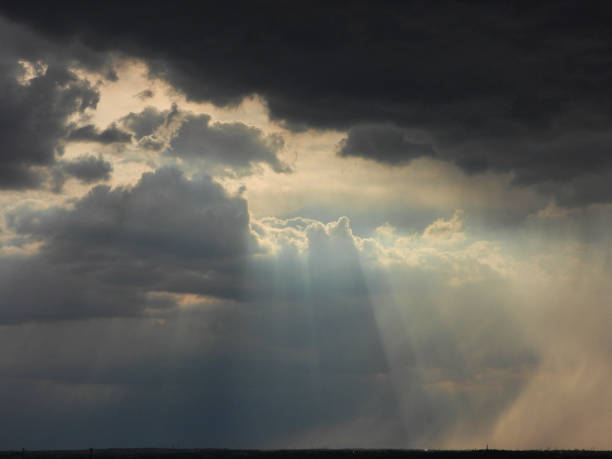 istock ray of sunshine in a menacing sky 1182036667