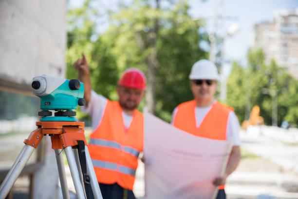 istock Construction team with blueprint and theodolite 1182038183
