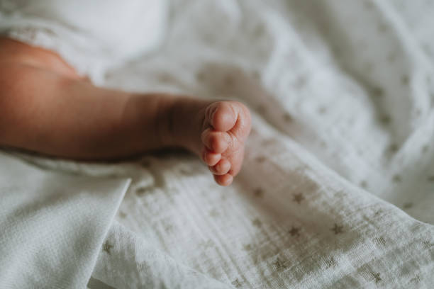 istock Low Section Of Baby Boy Lying On Bed 1182039890