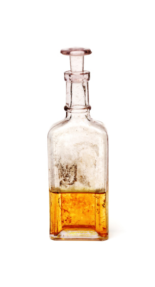 Glass bottle with stopper isolated on the background.