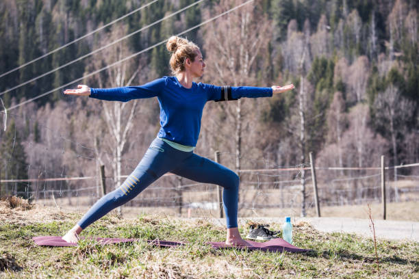 istock Young woman doing yoga warrior pose exercise. 1182049165