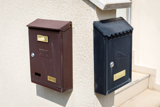 istock Old brown and black metallic retro post boxes on wall 1182050978