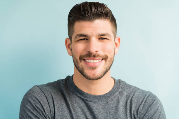 istock Good Looking Latin Man Against Turquoise Background 1182053512